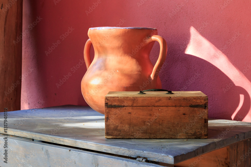 Europe, Spain, Balearic Islands, Mallorca. Esporles. Old table with pottery urn and wooden box.