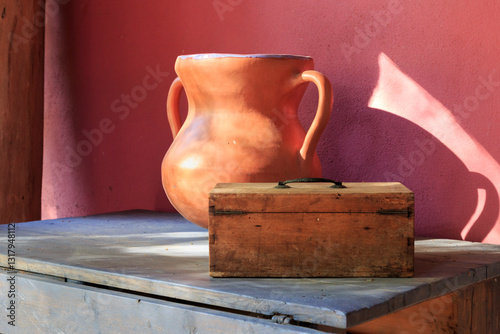Europe, Spain, Balearic Islands, Mallorca. Esporles. Old table with pottery urn and wooden box.