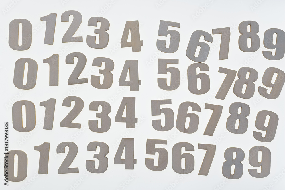 plain unpainted wood numbers arranged on a blank surface plain unpainted wood numbers arranged on a blank surface