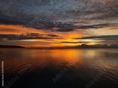 Golden Sunset Over a Tranquil Sea in the Philippines photo