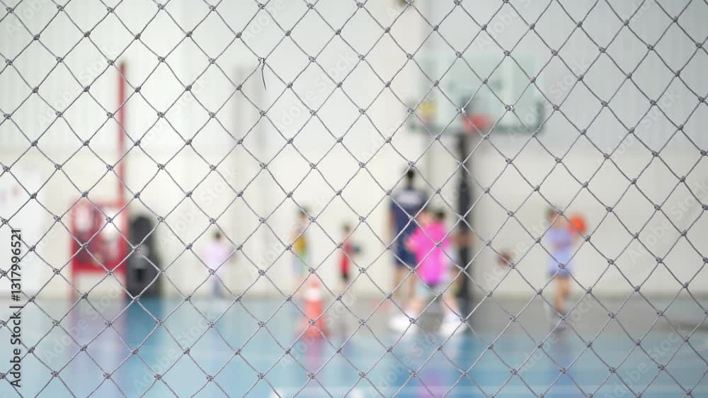 blur basketball court school by rope mesh net fence focus and many children or kids learning to shoot training playing basketball with coach and basketball hoop for healthy sport exercise slow motion