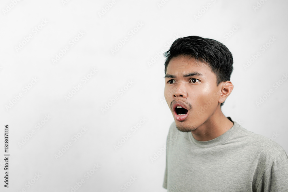 Asian man showing surprised expression when seeing something Asian man showing surprised expression when seeing something
