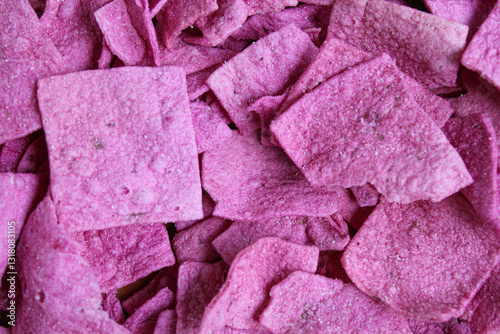 Purple sweet potato chips in square slices, flat lay or top view photo