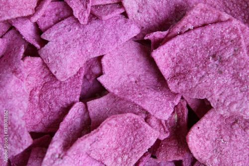 Purple sweet potato chips in square slices, flat lay or top view photo