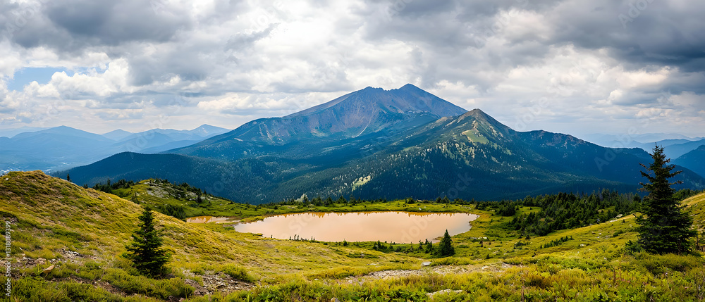 Fototapeta premium Panoramic View of Majestic Mountain Peak With An Alpine Lake And Cloudy Sky In The Background