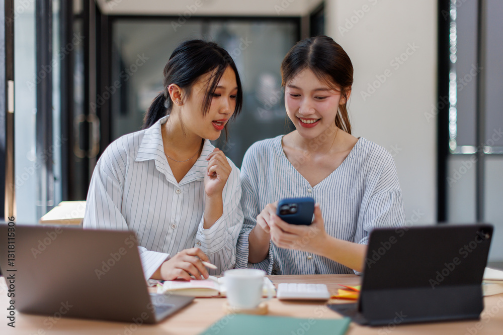 Two happy business asian women coworking with a laptop in a desktop at office
Two happy business asian women coworking with a laptop in a desktop at office