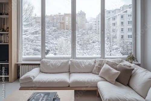 Cozy living room with sectional sofa overlooking snowy city view.