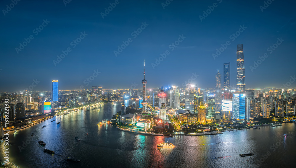 Fototapeta premium Aerial view of Shanghai skyline and river with lights at night