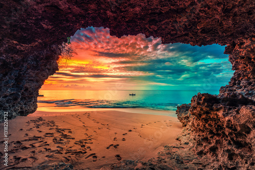 Fototapeta Naklejka Na Ścianę i Meble -  Beautiful view from mountain cave to tropical beach with colorful sunset above the ocean