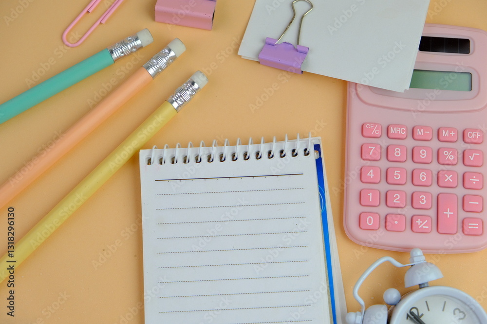 flat lay of a blank space for text. Educational and financial concept with text space on white background. surrounded by tools such as pen, alarm clock and calculator flat lay of a blank space for text. Educational and financial concept with text space on white background. surrounded by tools such as pen, alarm clock and calculator