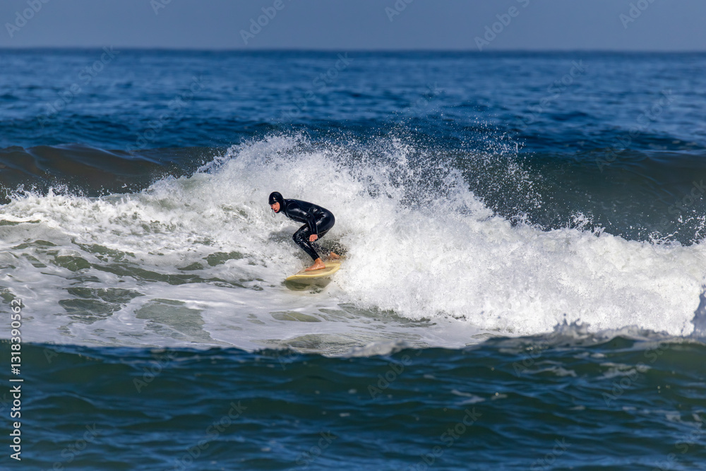 An athletic surfer is skillfully riding a spectacular wave along the stunningly beautiful coastline under the clear, bright blue skies, creating an exhilarating scene full of energy and excitement An athletic surfer is skillfully riding a spectacular wave along the stunningly beautiful coastline under the clear, bright blue skies, creating an exhilarating scene full of energy and excitement