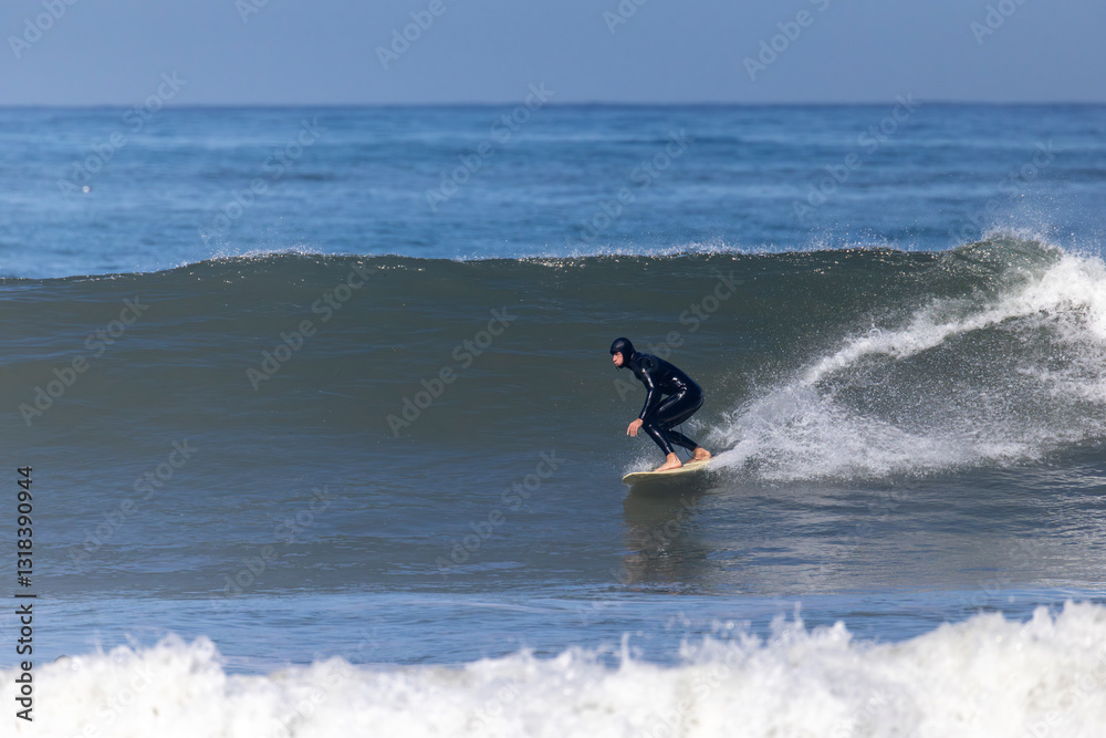 A skilled surfer gracefully rides a powerful wave on his surfboard in a vibrant ocean, captivating those who appreciate the artistry and thrill of surfing amid a stunning seascape A skilled surfer gracefully rides a powerful wave on his surfboard in a vibrant ocean, captivating those who appreciate the artistry and thrill of surfing amid a stunning seascape