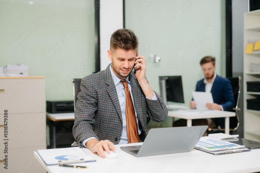 Confident businessman working on finance analysis with a tablet and laptop at office desk Confident businessman working on finance analysis with a tablet and laptop at office desk