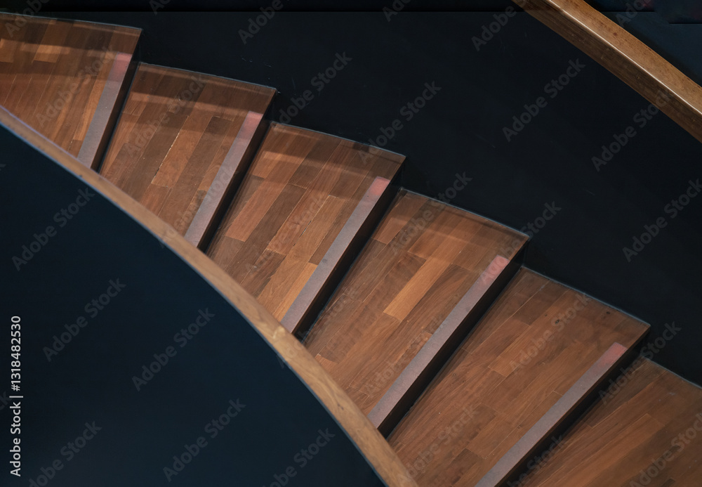 Layered wood spiral stairs with railings handle grip interior. View of Geometric shape of wooden curved staircase, Interesting architectural elements, use it as your Wallpaper, Poster and Copy space,