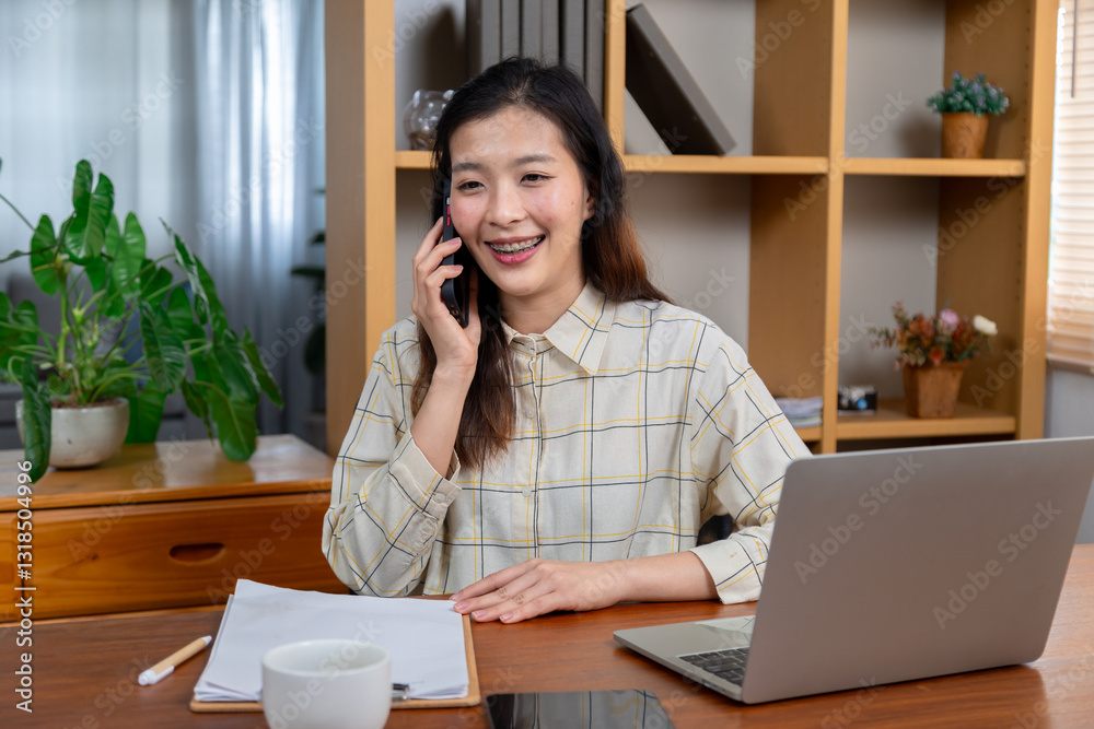 Businesswoman talk business team using smartphone for online meeting call at home office young Asian woman browsing site on cellphone,attractive young woman working with laptop on desk happy cheerful Businesswoman talk business team using smartphone for online meeting call at home office young Asian woman browsing site on cellphone,attractive young woman working with laptop on desk happy cheerful