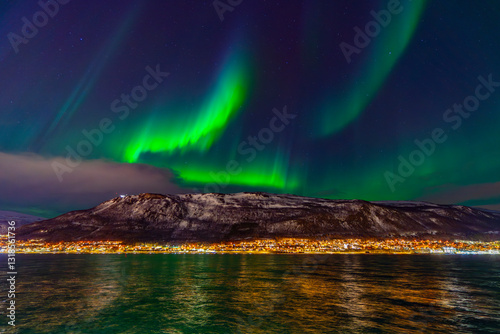 Tromsø, Troms, Norway - 28 February 2025 - The Norwegian sky is green with the magnificent Northern Lights over Tromsø photo