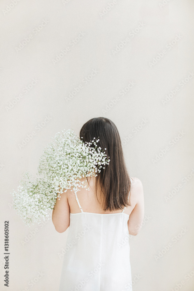 Woman Holding Gypsophila Flowers in White Dress Woman Holding Gypsophila Flowers in White Dress