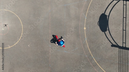 Aerial Birds Eye view of a child riding a bicycle 