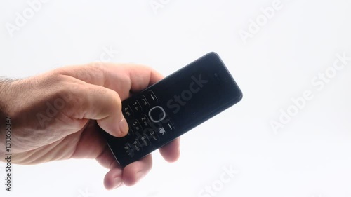 Wallpaper Mural male hands are using an old push-button mobile phone from the past Torontodigital.ca