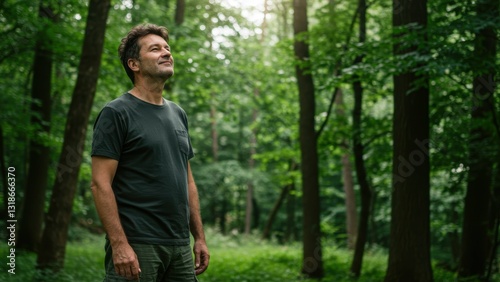 Middle aged Caucasian man enjoying nature in a forest, experiencing tranquility and self reflection Concepts of mindfulness and wellness