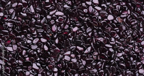 Top view of stack of polished Red whine Garnet chips turning 360°.