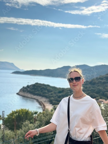 Coastal travel portrait of a woman by the sea, digital nomad and retreat vibe, blue water and island bay, summer vacation lifestyle, wellness slow travel and mindful escape, scenic background with cop