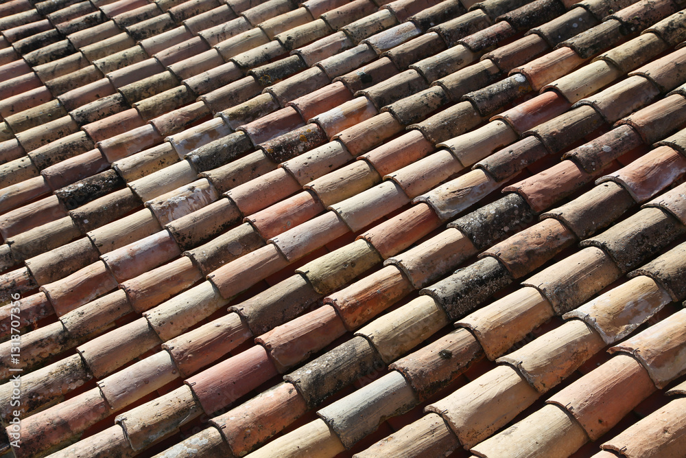 Weathered clay roof tiles showing pattern and texture in sunny outdoor setting during daytime Weathered clay roof tiles showing pattern and texture in sunny outdoor setting during daytime