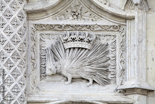 Stone relief of a porcupine with a crown displayed in Blois, France photo