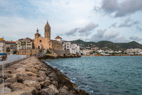 Iconic church of Sitges on the rocky coast overlooking the Mediterranean Sea photo