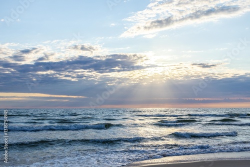 Fototapeta Naklejka Na Ścianę i Meble -  Sunset on the Baltic Sea coast in the Curonian Spit, Lithuania - 20.07.2024