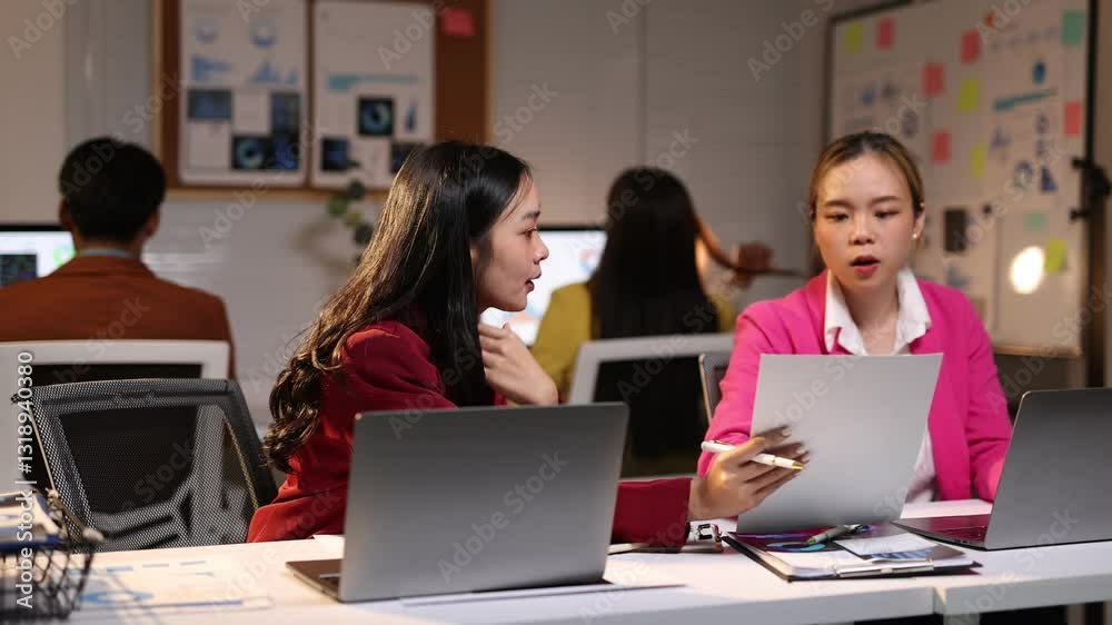 Businesswoman engage in discussion and colleagues while reviewing paperwork and working on laptops in office, collaboration and professional teamwork. Businesswoman engage in discussion and colleagues while reviewing paperwork and working on laptops in office, collaboration and professional teamwork.