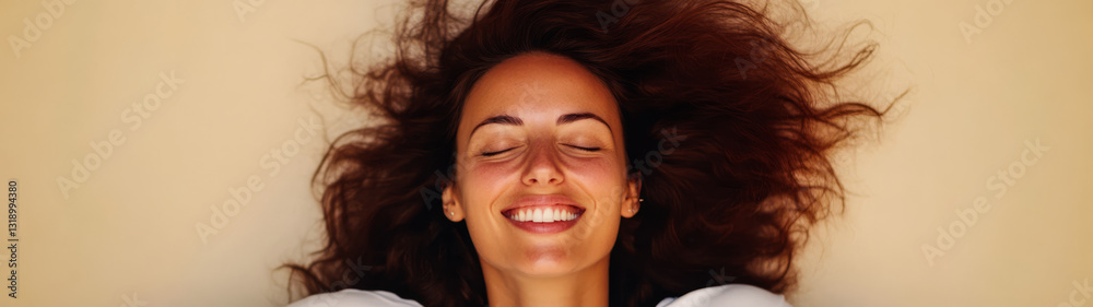 Smiling woman with flowing hair relaxing on sandy beach during bright day Smiling woman with flowing hair relaxing on sandy beach during bright day