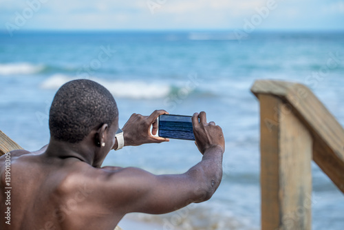 Man Taking Photo of Sea