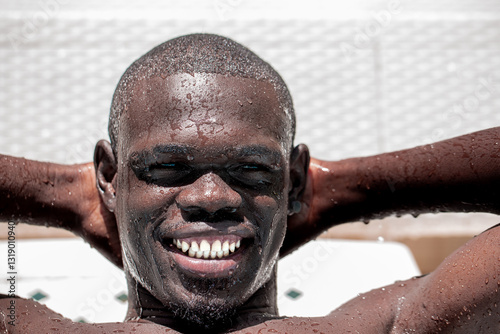 African Man Smiling with Water Droplets