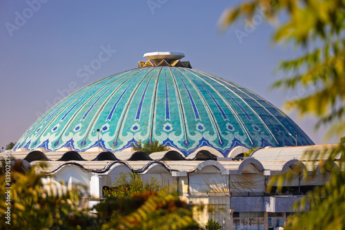 View on turquoise main dome of the Chorsu bazaar or Eski juva bazaar at Tashkent, Uzbekistan. Blurred foreground