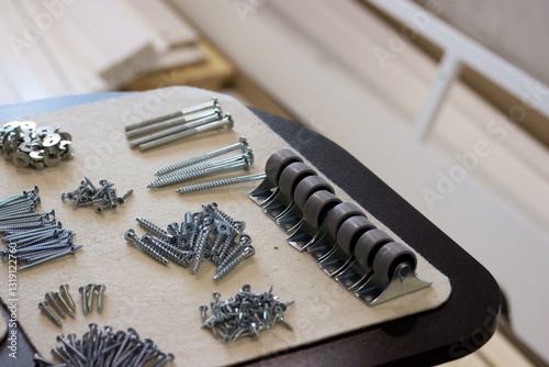Set of fasteners for assembling an ottoman. Laid out for convenience. Close-up view.