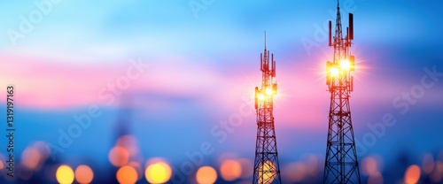 Two cell phone towers against clear sky representing modern communication infrastructure and technological advancements