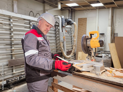 Man carpenter holds board i...