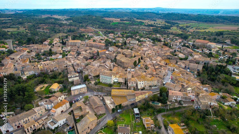 Aerial view of the city Castelnau-de-Guers in France on a sunny morning in early spring Aerial view of the city Castelnau-de-Guers in France on a sunny morning in early spring