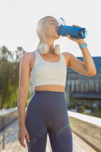 Принти на полотні Athletic fit sport runner girl drinking water from bottle after training exercise