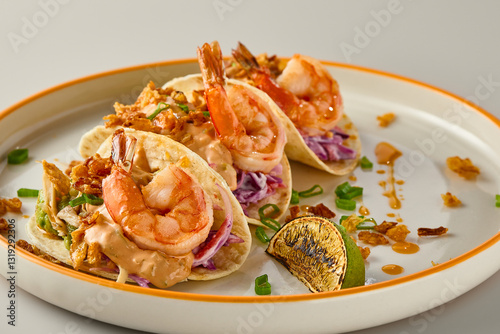 Vibrant Shrimp Tacos on Elegant Plate with Citrus Accent photo