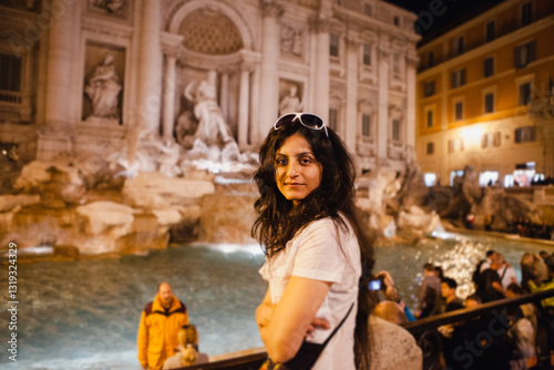 Canvas Print EUROTRIP - An attractive woman graces the foreground of the Trevi Fountain at night time in Rome, Italy