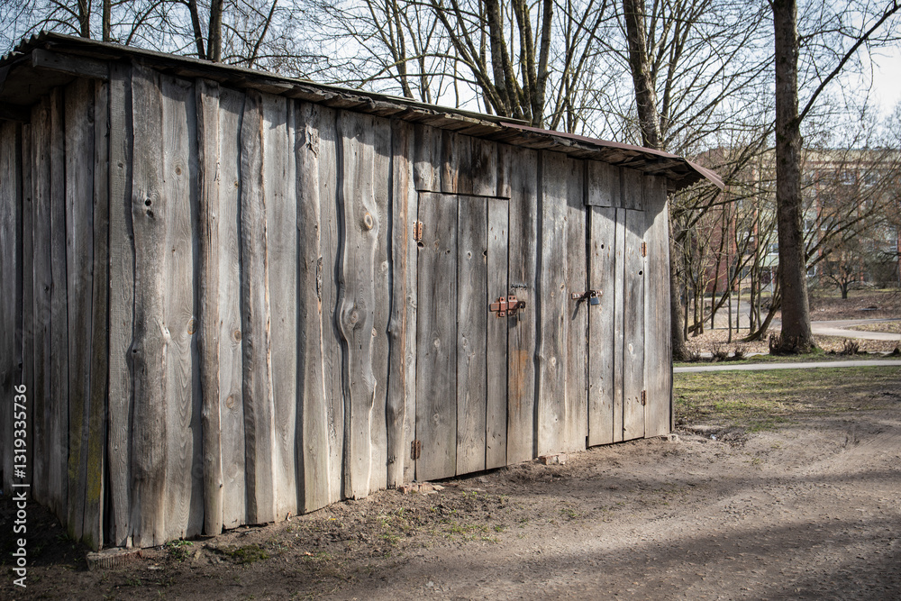 Weathered Wooden Shed with Hinged Doors and Rusty Locks Weathered Wooden Shed with Hinged Doors and Rusty Locks