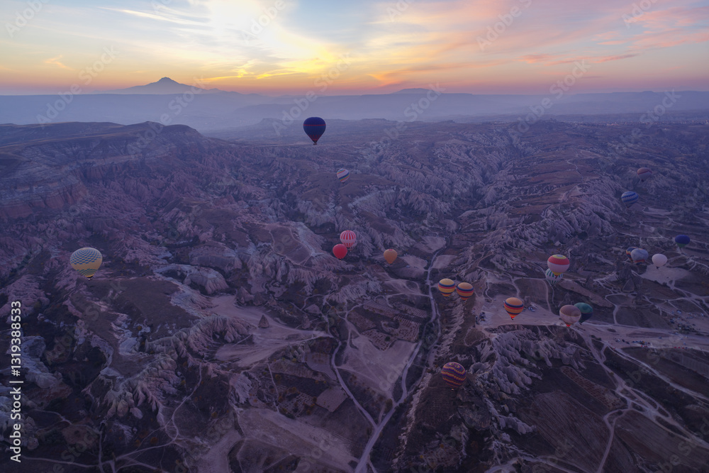 Early morning view of hot air balloons rising up in Cappadocia, Turkey