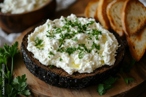 Creamy whipped feta dip garnished with fresh parsley and a drizzle of olive oil served on a slice of rye bread