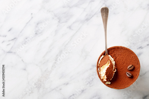 Tiramisu dessert in glass. Marble background. Copy space. Top view.