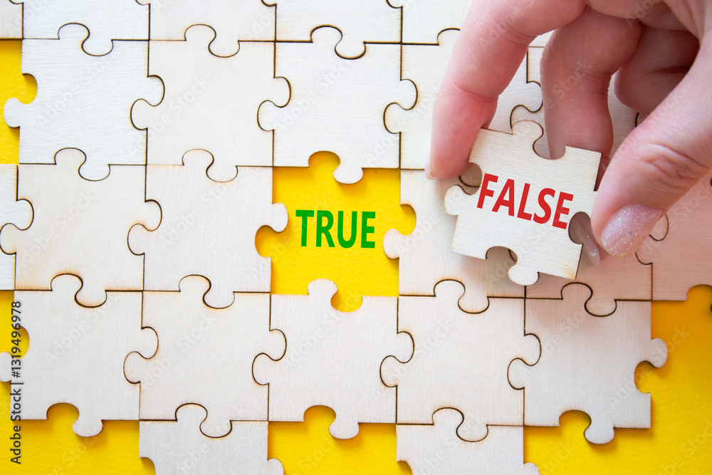 True or False symbol. Concept word True or False on wooden puzzle. Businessman hand. Beautiful yellow background. Business and True or False concept. Copy space True or False symbol. Concept word True or False on wooden puzzle. Businessman hand. Beautiful yellow background. Business and True or False concept. Copy space