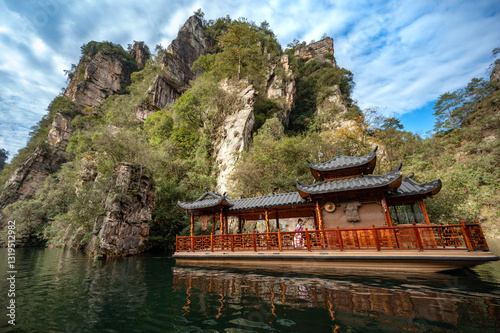 Boat tour in Baofeng lake in the Wulingyuan scenic area. Beautiful lush landscape in Zhangjiajie National Forest Park. photo