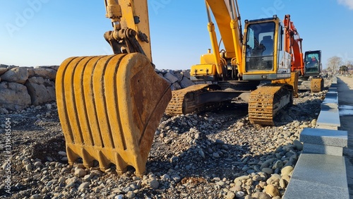 Yellow excavator among rocks at a work site