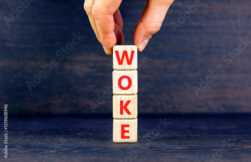Woke question symbol. Concept word Woke question on beautiful wooden blocks. Businessman hand. Beautiful black table black background. Business, lifestyle, support woke question concept. Copy space.